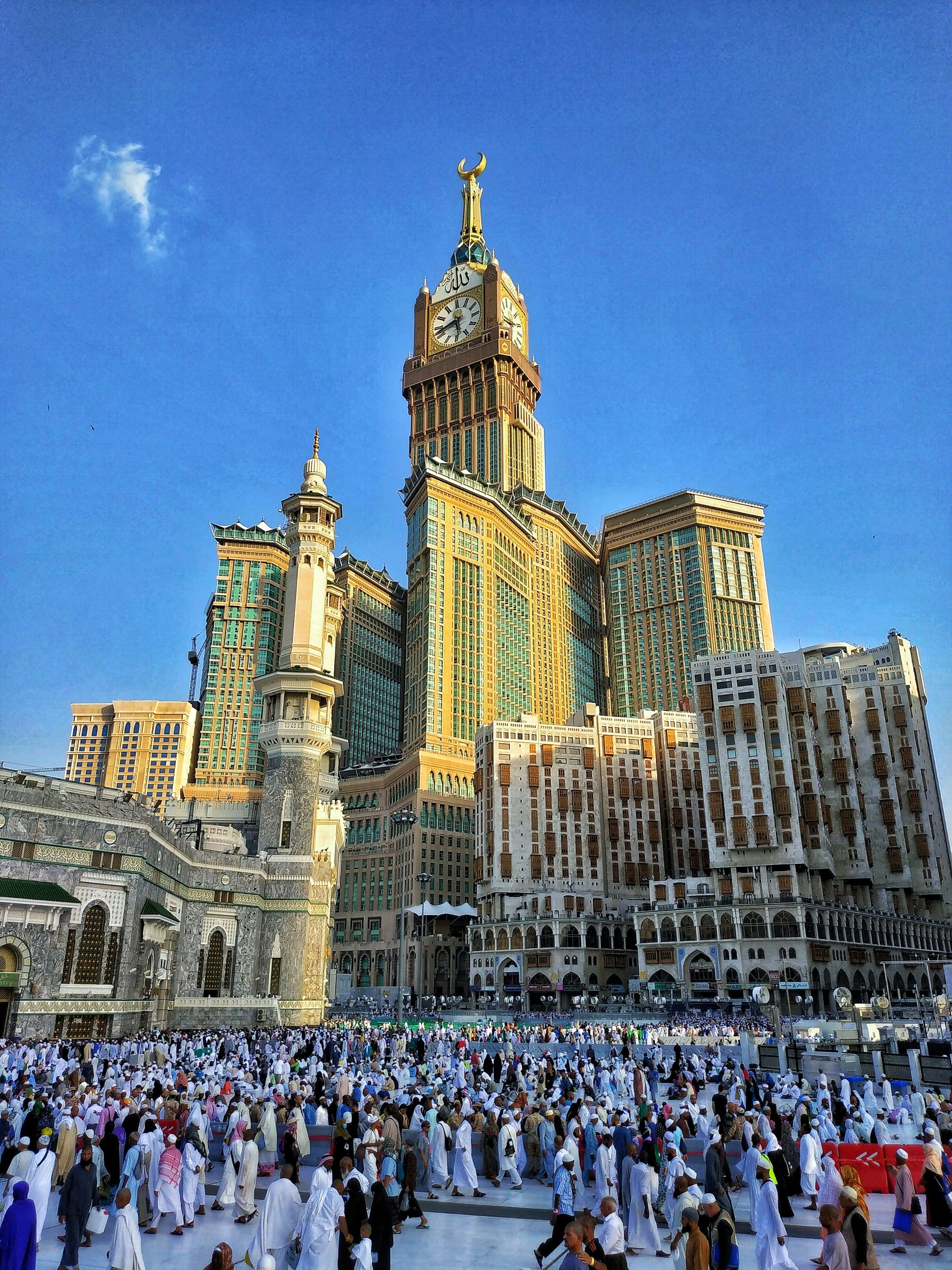 Crowds walking across the plaza below the Makkah hotel towers